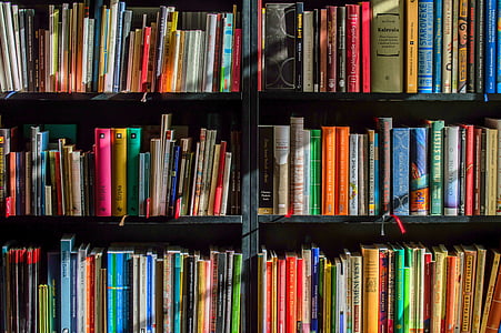 assorted books in black wooden shelf thumbnail