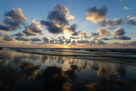 body of water under cloudy sky during daytime thumbnail