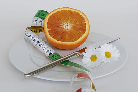 slice orange fruit on white ceramic plate thumbnail