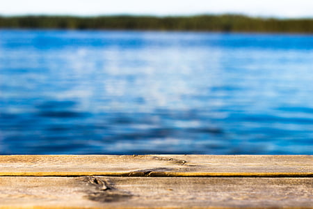 close-up photo of beige wood panel near body of water thumbnail