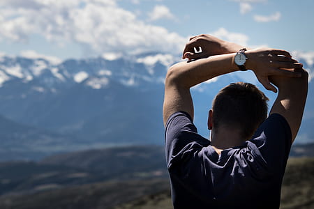 man raising two hands during daytime thumbnail