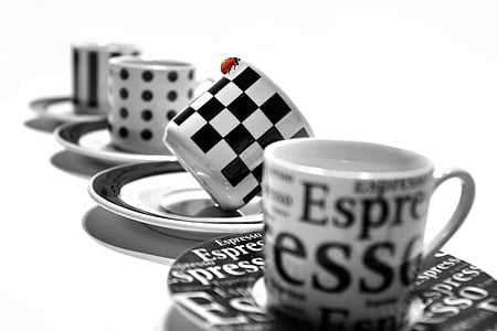 selective focus photography of white and black checked ceramic teacup on saucer thumbnail