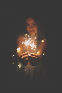 woman wearing white dress holding sprakler sticks thumbnail