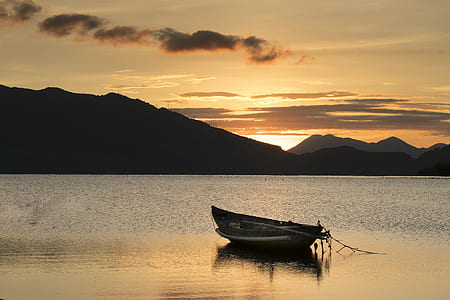 boat on body of water during sunset thumbnail