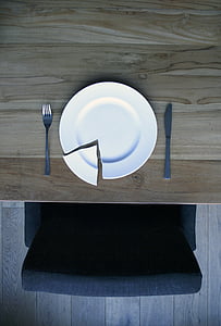 broken round white ceramic plate between gray stainless steel fork and butter spreader thumbnail