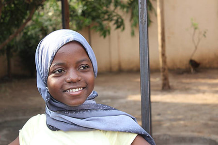 girl smiling wearing purple kiffeyeh thumbnail