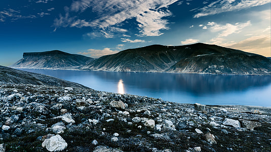 body of water surrounded by mountains natures photography thumbnail