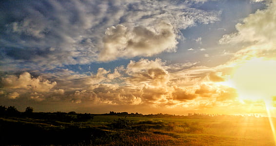 Green Grass Field Under Cloudy Sky during Sunset thumbnail