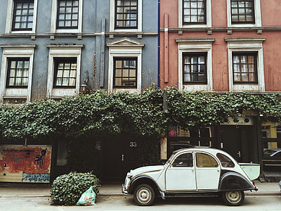 white mini cooper on front of building thumbnail