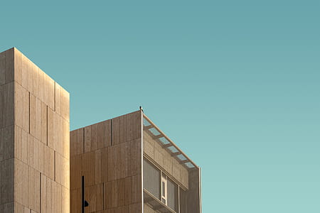 high rise photo of brown building at daytime thumbnail