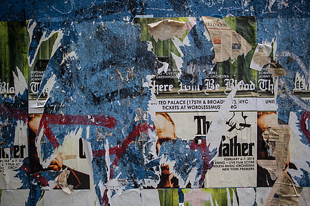 Wide angle shot of torn flyers and posters on a wall in Brooklyn, New York City thumbnail