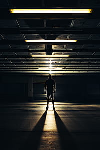 silhouette of man standing near gate thumbnail