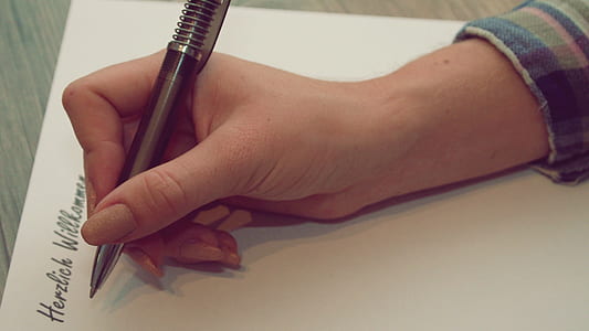 person holding black pen thumbnail