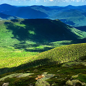 aerial view photo of mountains under blue sky during daytime thumbnail