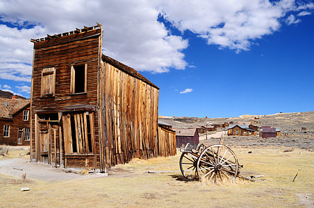 black wagon beside brown wooden house thumbnail