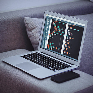 MacBook Air on gray couch arm thumbnail