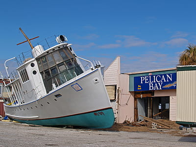 white and blue ship beside Pelican Bay store thumbnail