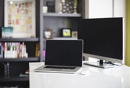 MacBook Pro on top of white wooden table thumbnail