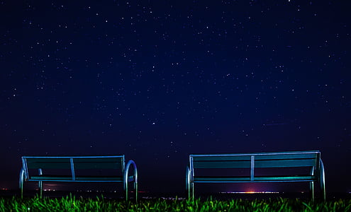 two silver metal bench on green grass field thumbnail
