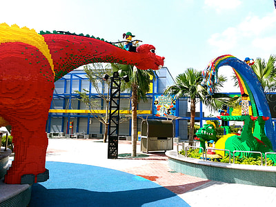 red dinosaur statue near trees thumbnail
