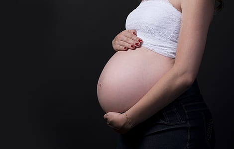 closeup photo of a pregnant woman holding her tummy thumbnail
