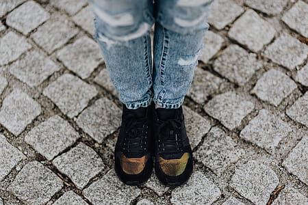 Woman in black sneakers and blue jeans thumbnail