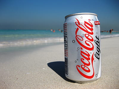 close-up photography of Coca-Cola Light can on beach thumbnail