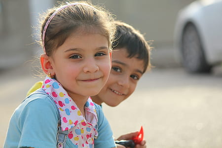 photography of two girl and boy sitting to each other thumbnail