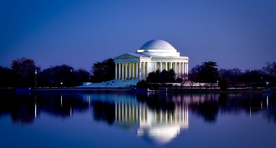 white concrete building near body of water thumbnail