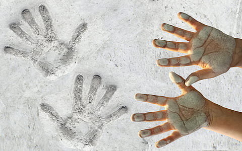 person hands on mark on sand thumbnail