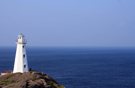 white painted lighthouse near body of water thumbnail