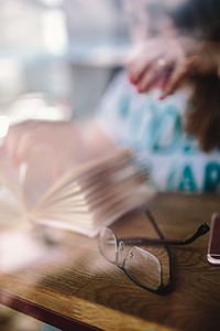 Woman reading book at coffee shop thumbnail