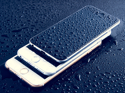 three assorted-color iPhones with water drops thumbnail