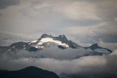 mountain covered with snow and fog thumbnail
