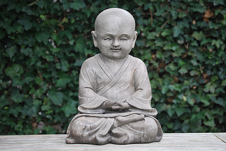 meditating monk statue on platform thumbnail