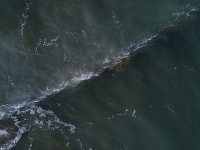 aerial view of green ocean water during daytime thumbnail