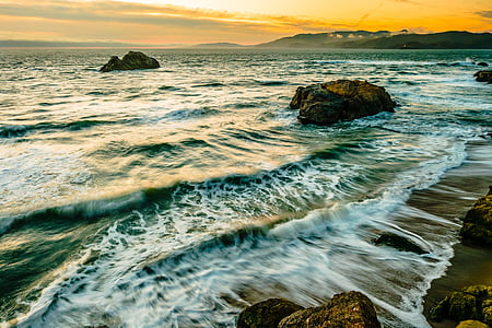 body of water near rock thumbnail