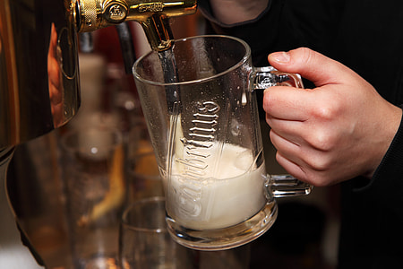 person holding clear glass beer mug refilling thumbnail