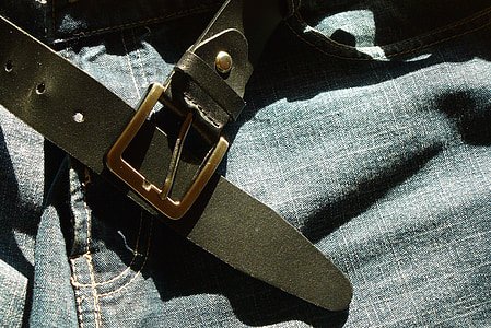 black leather belt on blue denim bottoms thumbnail