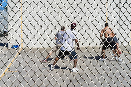 four men playing basketball during daytime thumbnail