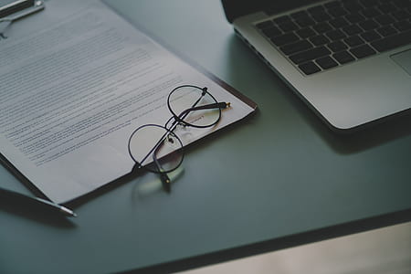 eyeglasses with black frames beside laptop computer thumbnail