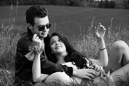 woman in dress lying on man in jacket thumbnail