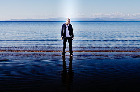 man standing on seashore thumbnail