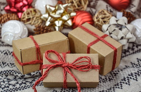 three closeup photo of brown-and-red tied boxes thumbnail