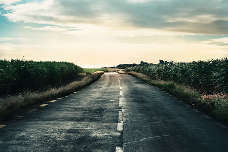 black asphalt road under white clouds thumbnail