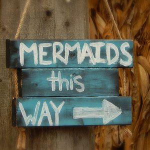 photo of mermaids this way signage thumbnail