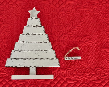 white wooden Christmas tree decor on red textile thumbnail