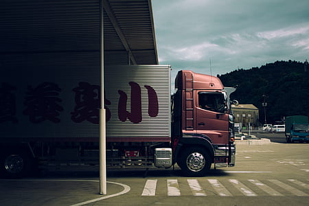 red and grey truck on road thumbnail