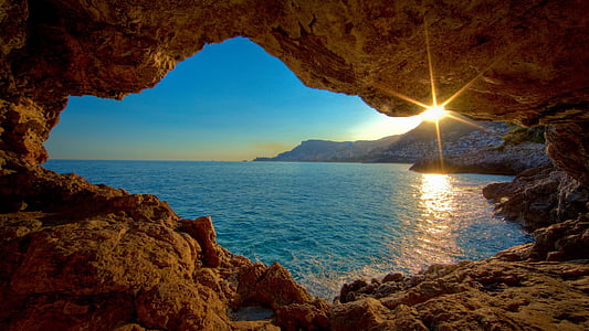 landscape photography of seaside in cavern during daytime thumbnail