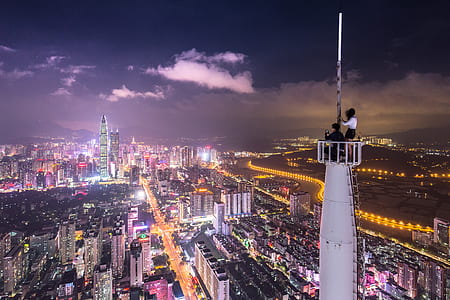 person standing on white tower during nighttime thumbnail